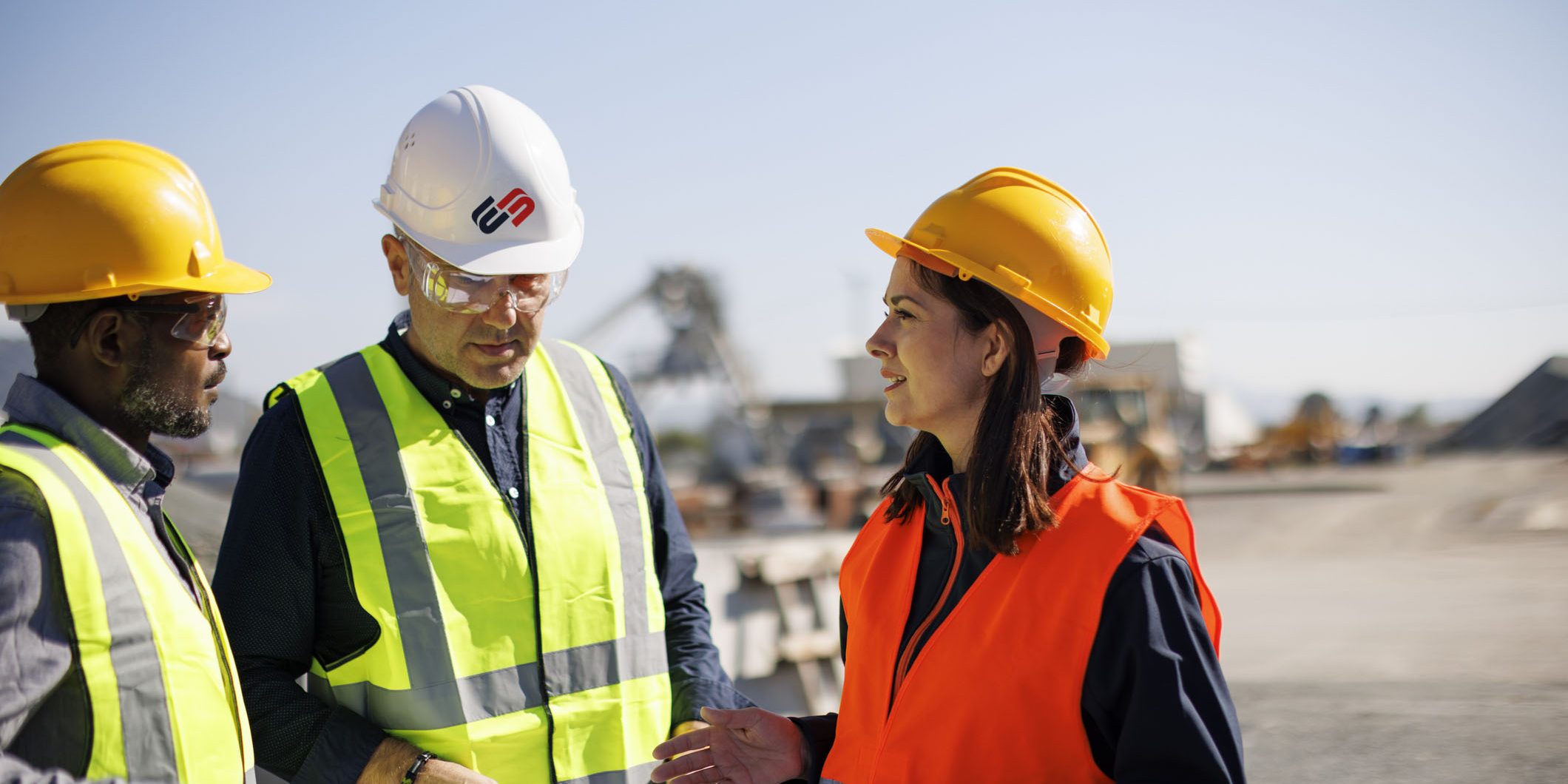 Engineers and architect discussing building plan at construction site